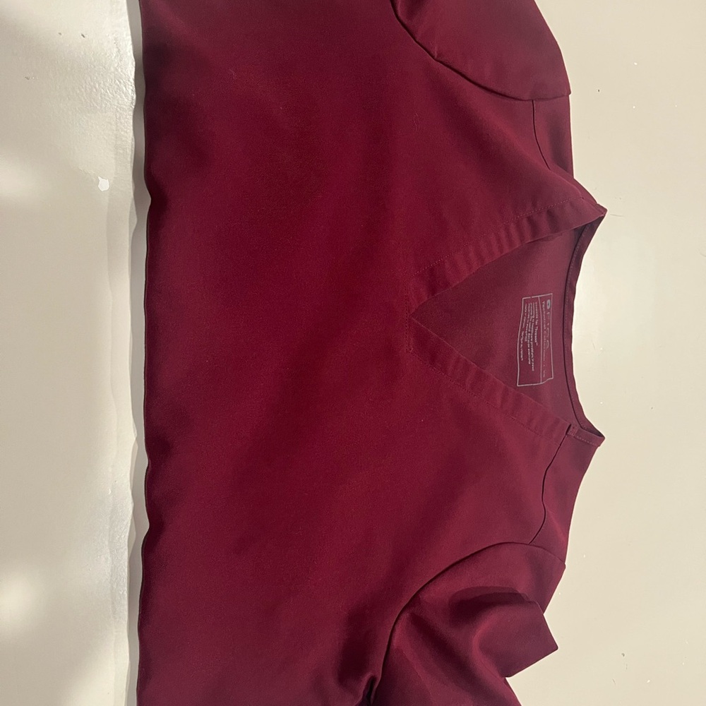 Figs Burgundy V-Neck Scrub top with three pockets.